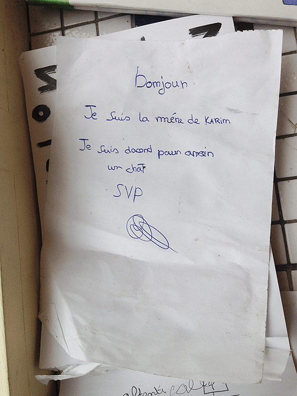 "I'm Karim's mum, I agree to have a cat. Please". A photograph of a signed note, left at the local café downstairs from my studio at the time. I don’t think so, Karim. - © Maciek Pożoga